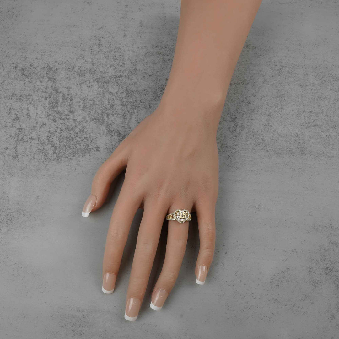 10k - 14k Hand wearing a  Quinceanera Heart ring on a gray background