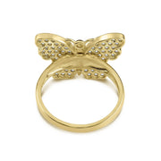Backside view of a gold cubic zirconia butterfly ring against a clean background.