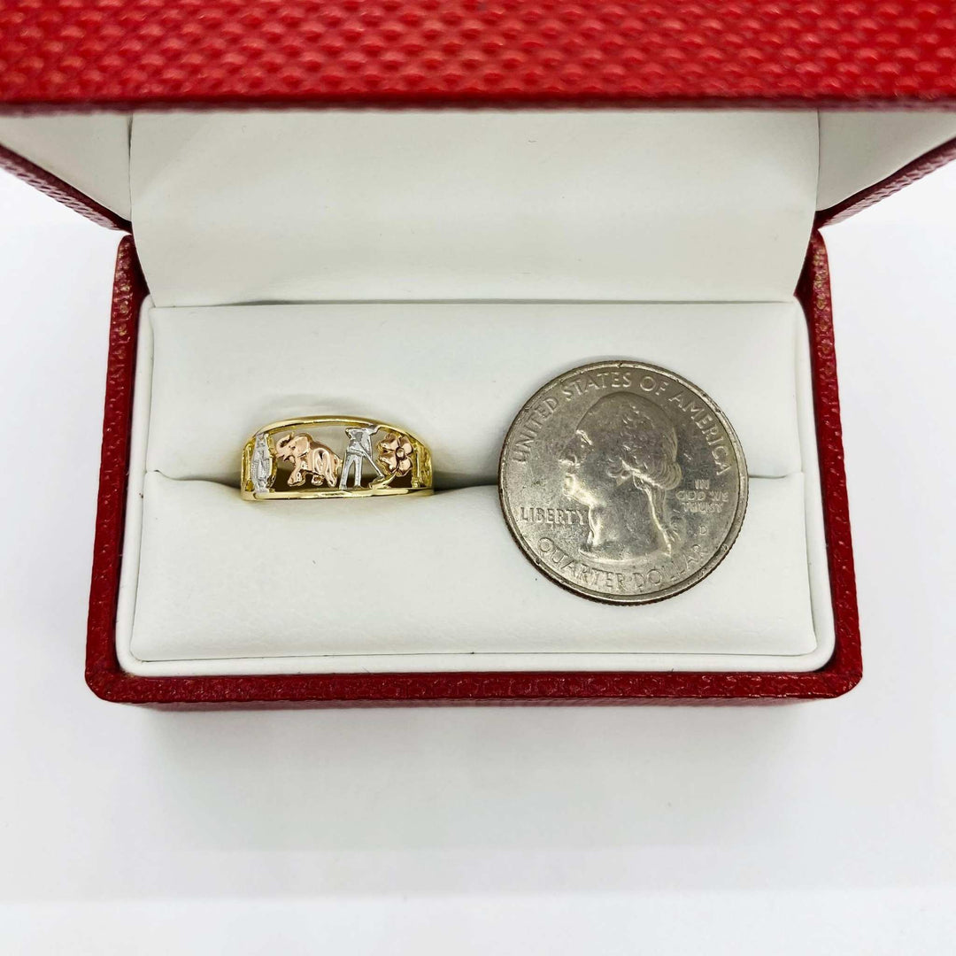 10k - 14k Gold ring with elephant ring features and a lucky tri color design in a red box next to a silver dollar coin.