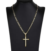 Gold CZ cross pendant on Figaro chain presented on a black mannequin bust.