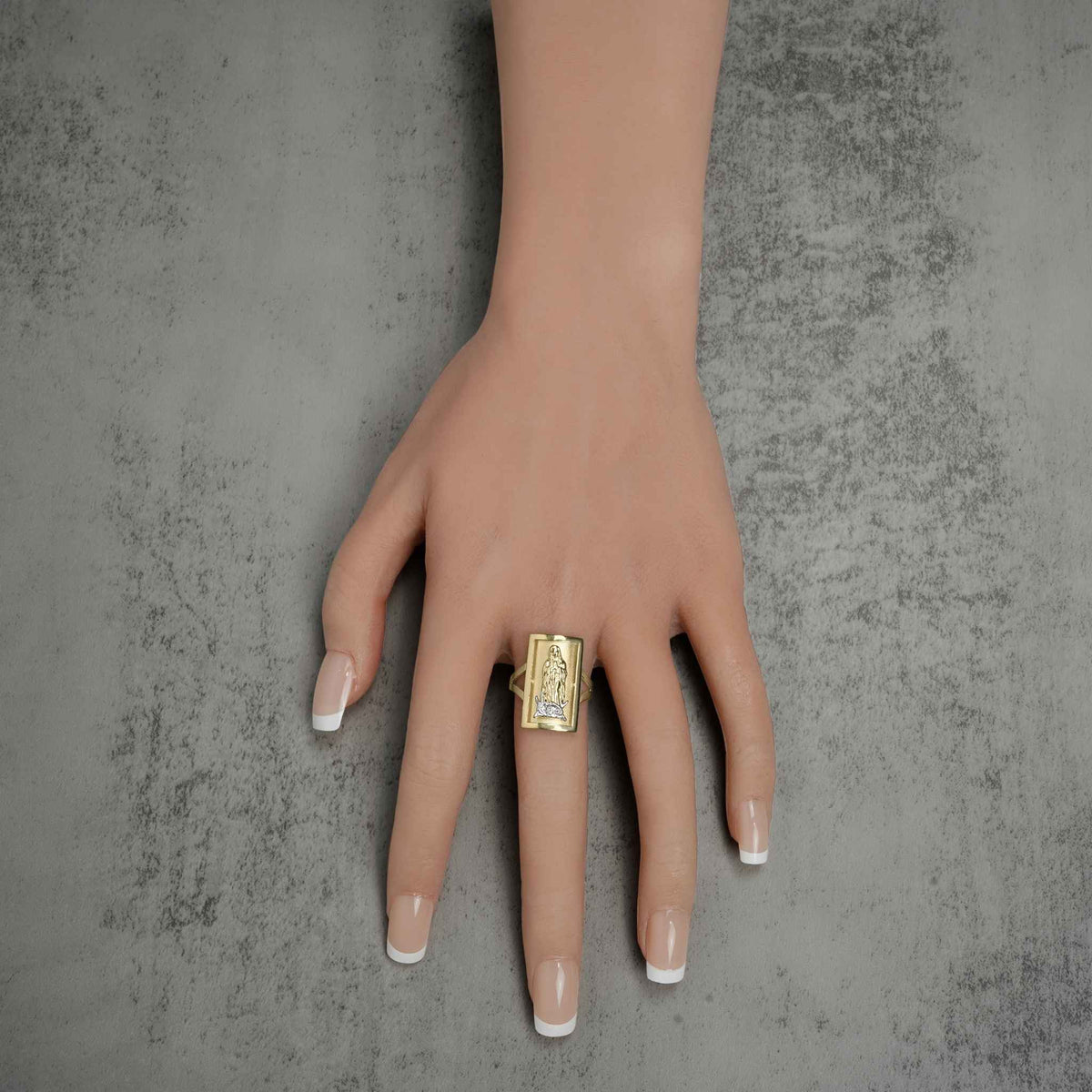 Macro view of the intricate Our Lady of Guadalupe engraving on the Luxora gold ring.