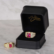 Luxury black Nolters jewelry box showcasing two gold rectangle ruby-colored rings on marble.