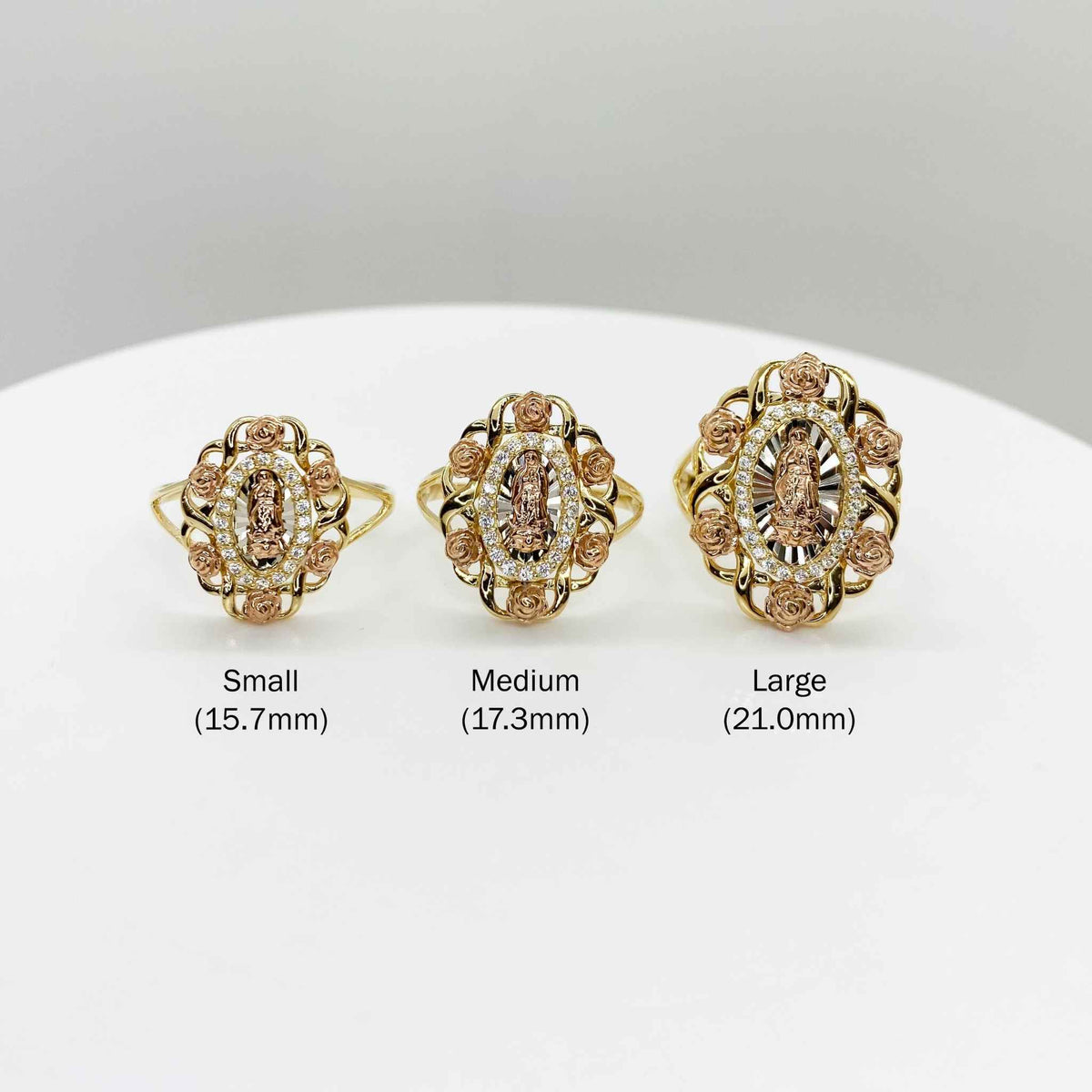 Three 10k - 14k Virgin Mary Guadalupe tri-color gold rings of different sizes.