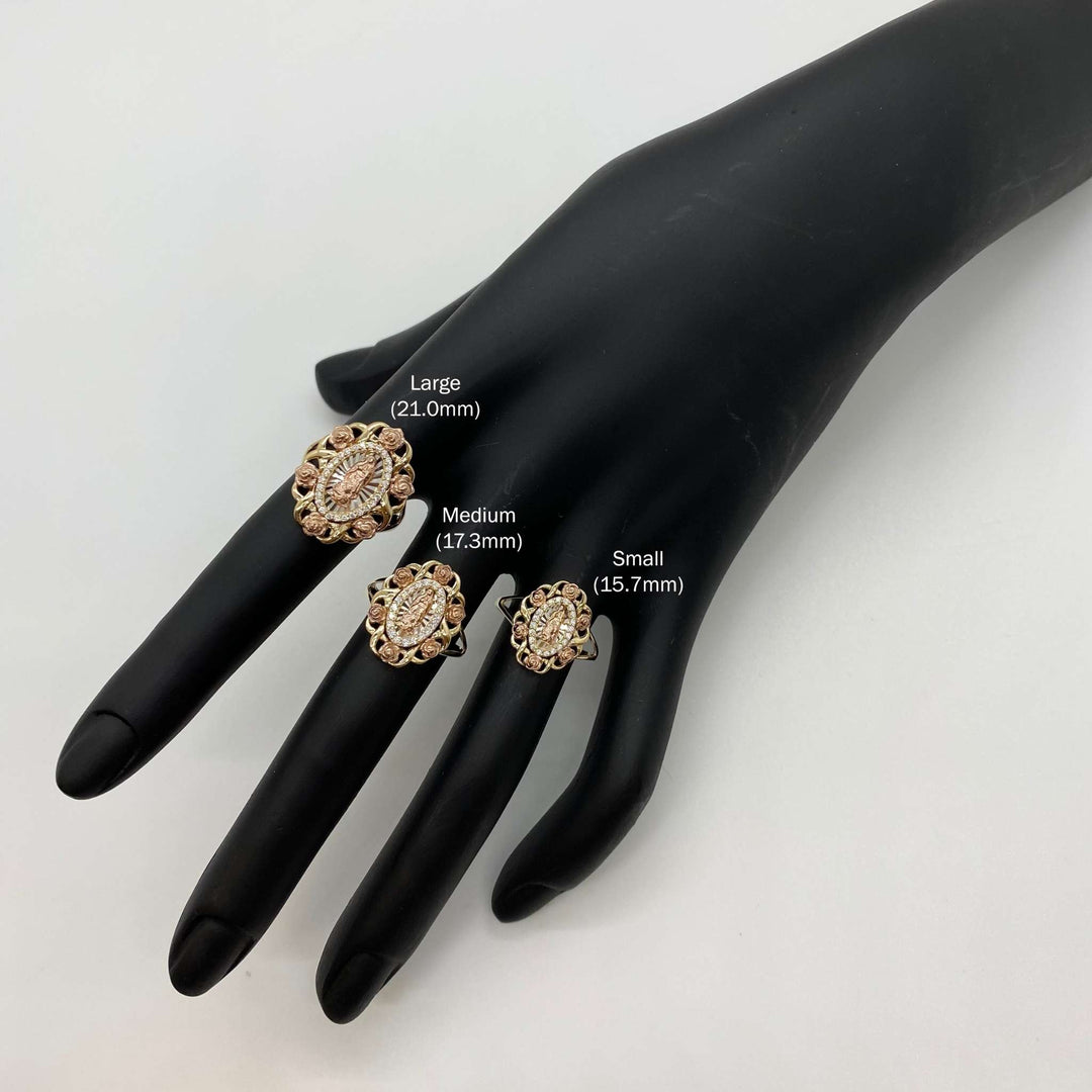 Three 10k - 14k gold Virgin Mary Guadalupe rings on a black mannequin hand.