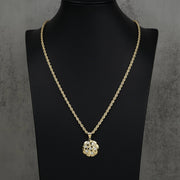 Textured gold round pendant and rope chain necklace displayed on a black mannequin.