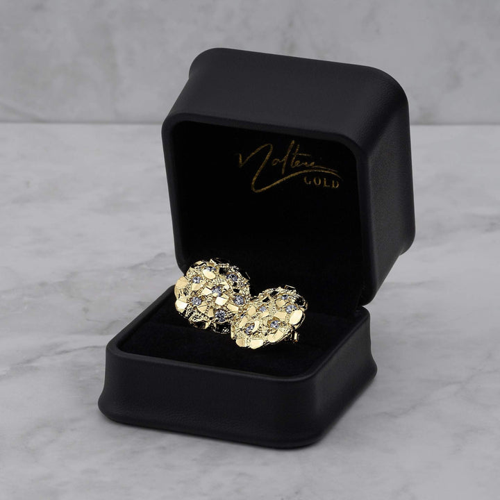 Two gold nugget round cubic zirconia stud earrings displayed inside an open black jewelry box.