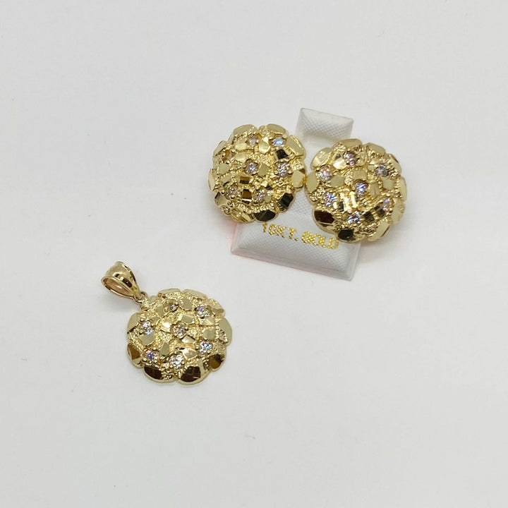 Gold nugget round cubic zirconia stud earrings displayed next to a matching pendant.