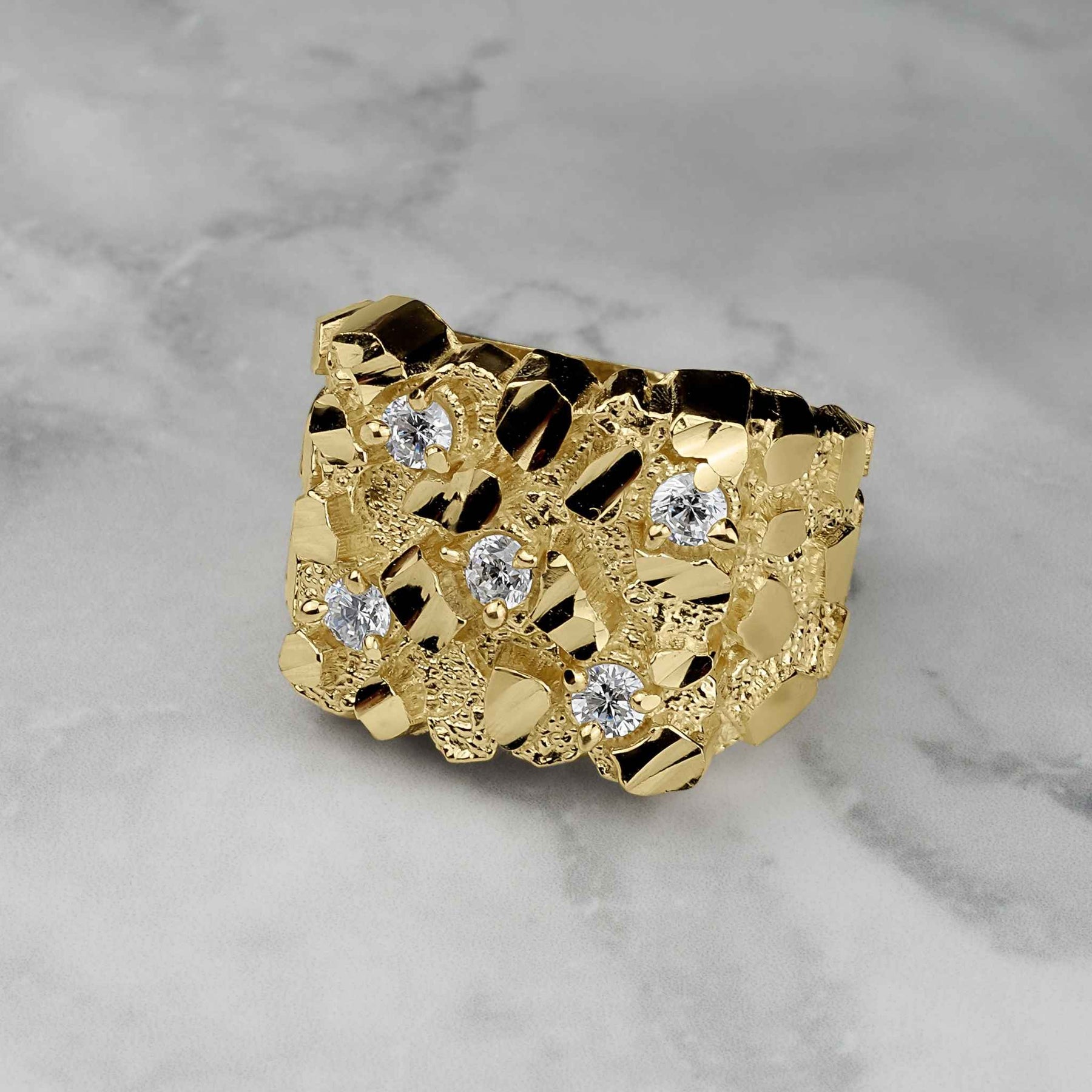 A gold classic square nugget ring featuring five clear cubic zirconia accents on marble.