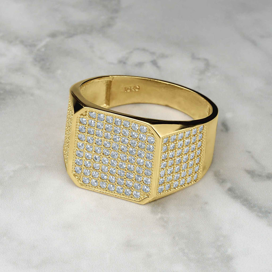 Gold Oren square signet cubic zirconia ring for men on marble background.