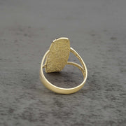 10k - 14k Gold ring with a textured oval shaped design back view on a gray background