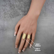 two 10k - 14k Gold ring on a hand with size labels on a gray background