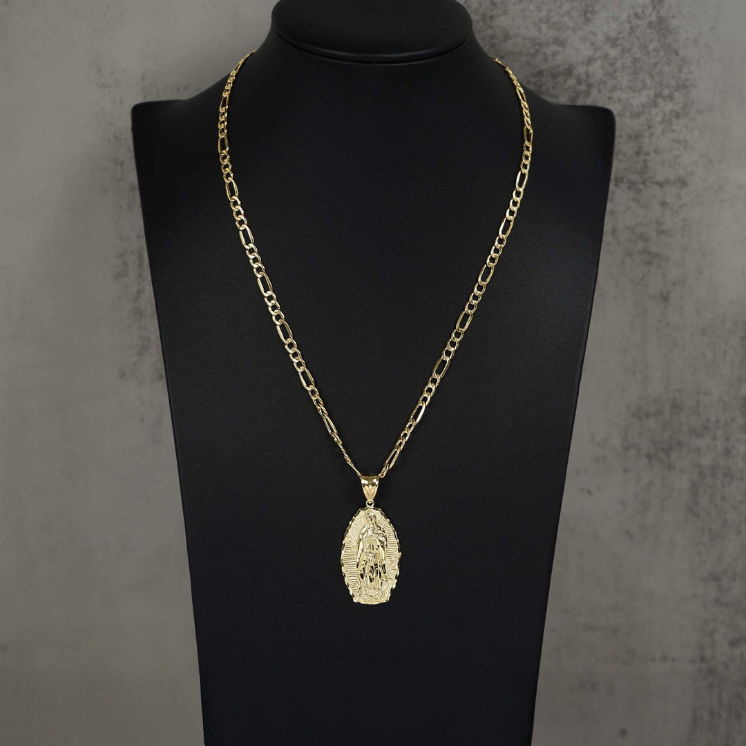 Gold chain necklace with an oval Guadalupe pendant displayed on a black jewelry mannequin bust.