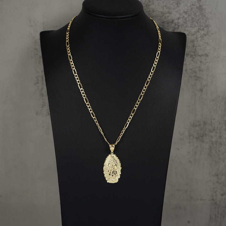 Gold chain necklace with an oval Guadalupe pendant displayed on a black jewelry mannequin bust.