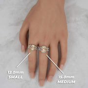 Model displaying small and medium sizes of a tricolor gold birthday ring.