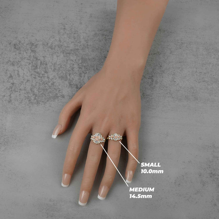 Hand wearing two rings with size labels on a gray background