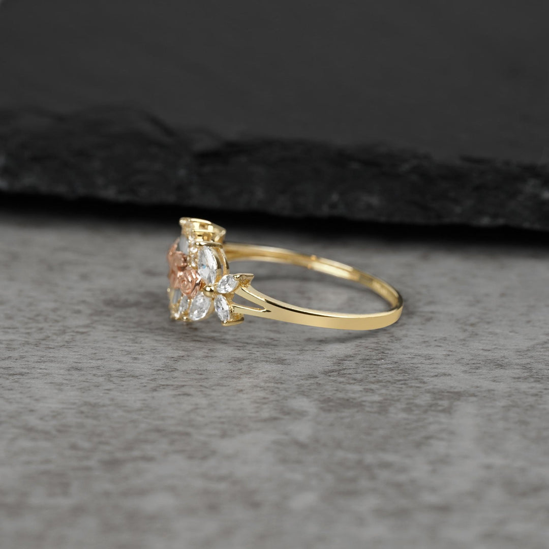 10k - 14k Gold ring with floral design on a gray surface