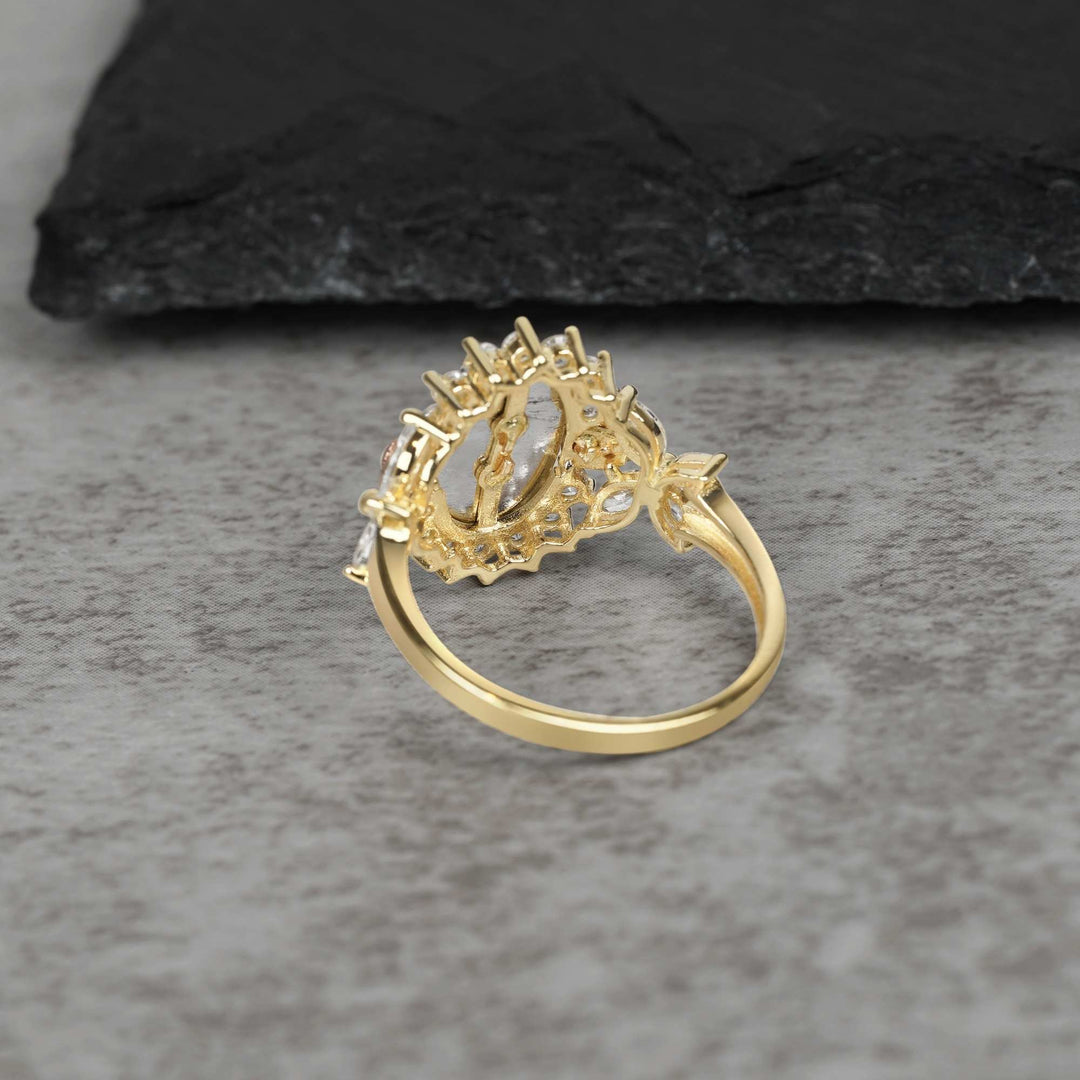 10k - 14k Gold ring with intricate design on a gray surface