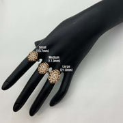 Three 10k - 14k gold  Quinceanera Bloom Rose rings on a black mannequin hand .