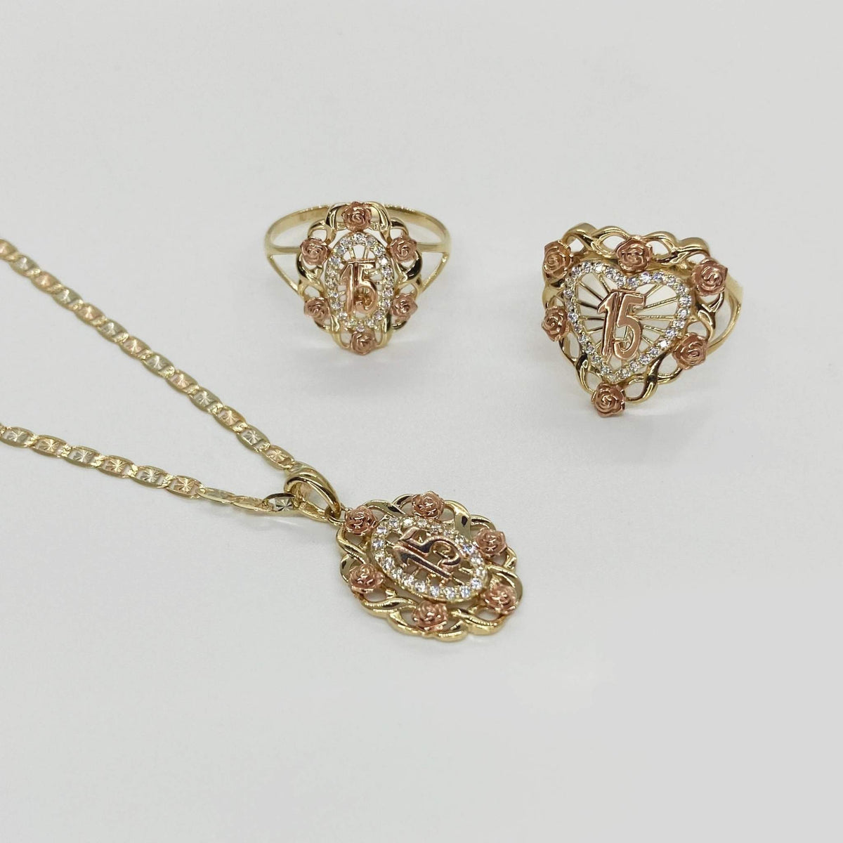 10k - 14k Gold jewelry set with necklace, ring, and heart-shaped pendant.