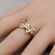 Close-up of a 10k or 14k gold butterfly Quinceañera ring on a hand.