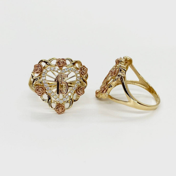 two 10k - 14k Gold Quinceanera ring with heart design and rose accents on a light background