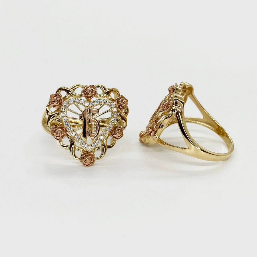 two 10k - 14k Gold Quinceanera ring with heart design and rose accents on a light background