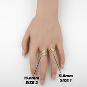 Hand wearing two gold Quinceañera rings showing Size 1 and Size 2 comparison.