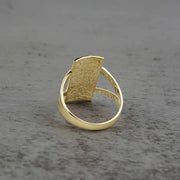 10k - 14k Gold ring with textured rectangular design backview on a gray surface
