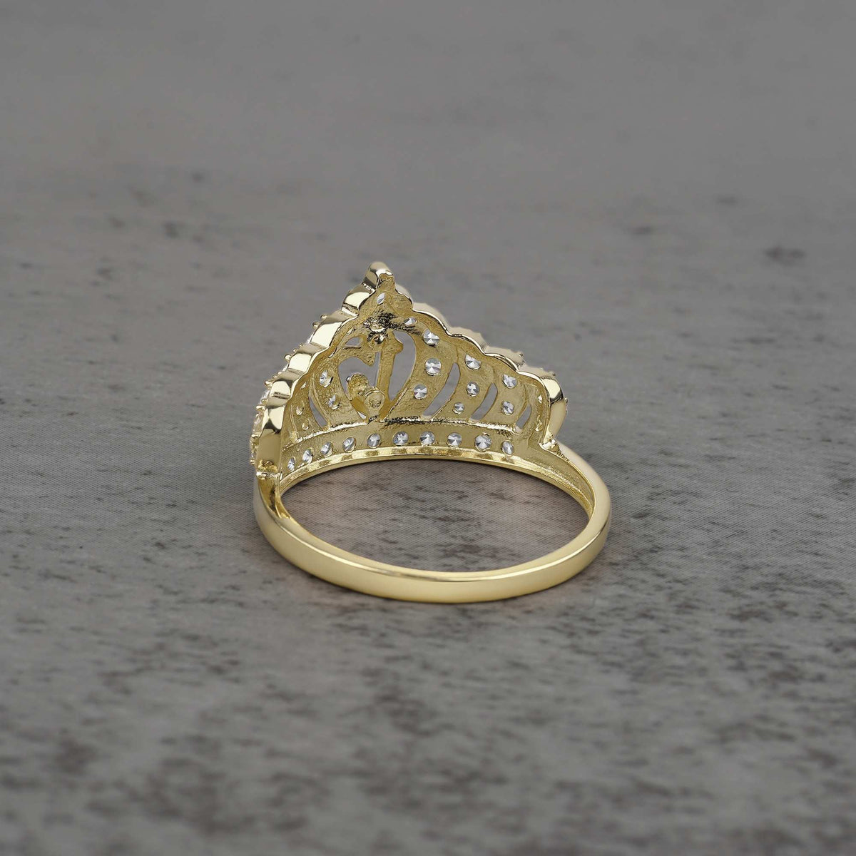 10k - 14k Gold crown-shaped ring back view on a gray surface