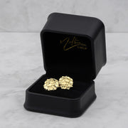 10k and 14k gold round nugget stud earrings inside an open black jewelry box.