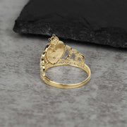 Back angle of 14k gold royal quinceanera crown ring with cubic zirconia stones.