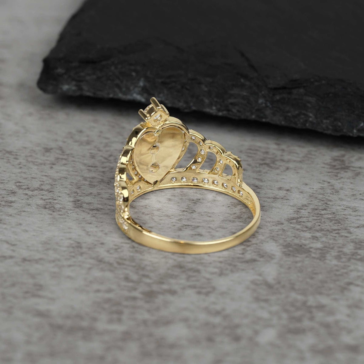 Back angle of 14k gold royal quinceanera crown ring with cubic zirconia stones.