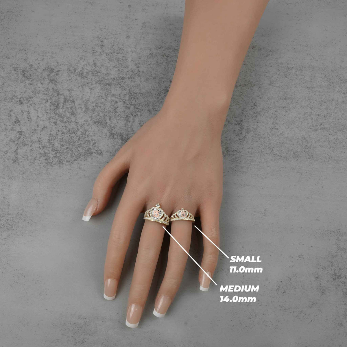 Small and medium gold royal crown rings on a hand with size labels.