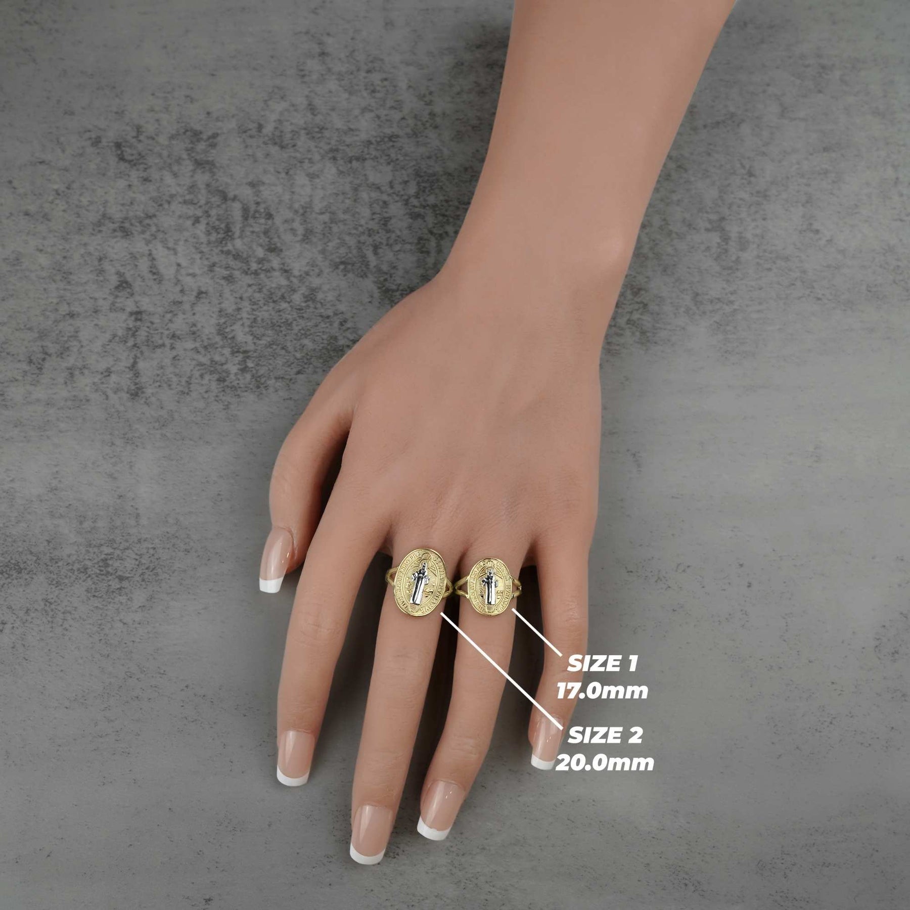 Hand wearing two 10k - 14k  Classic Saint Benedict Oval gold rings with size labels 