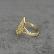 10k - 14k Saint Benedict Oval gold Ring  sideview on a gray background