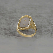 Back view of a two-tone gold San Judas ring showing the intricate band construction.