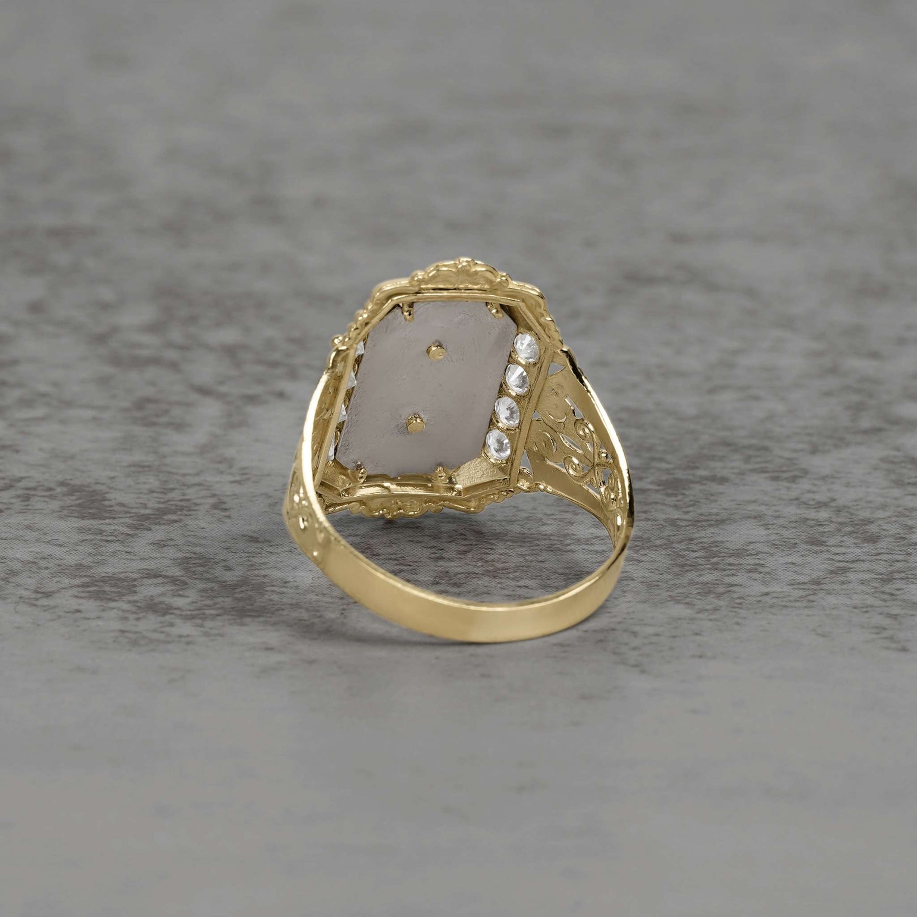 Back view of a two-tone gold San Judas ring showing the intricate band construction.
