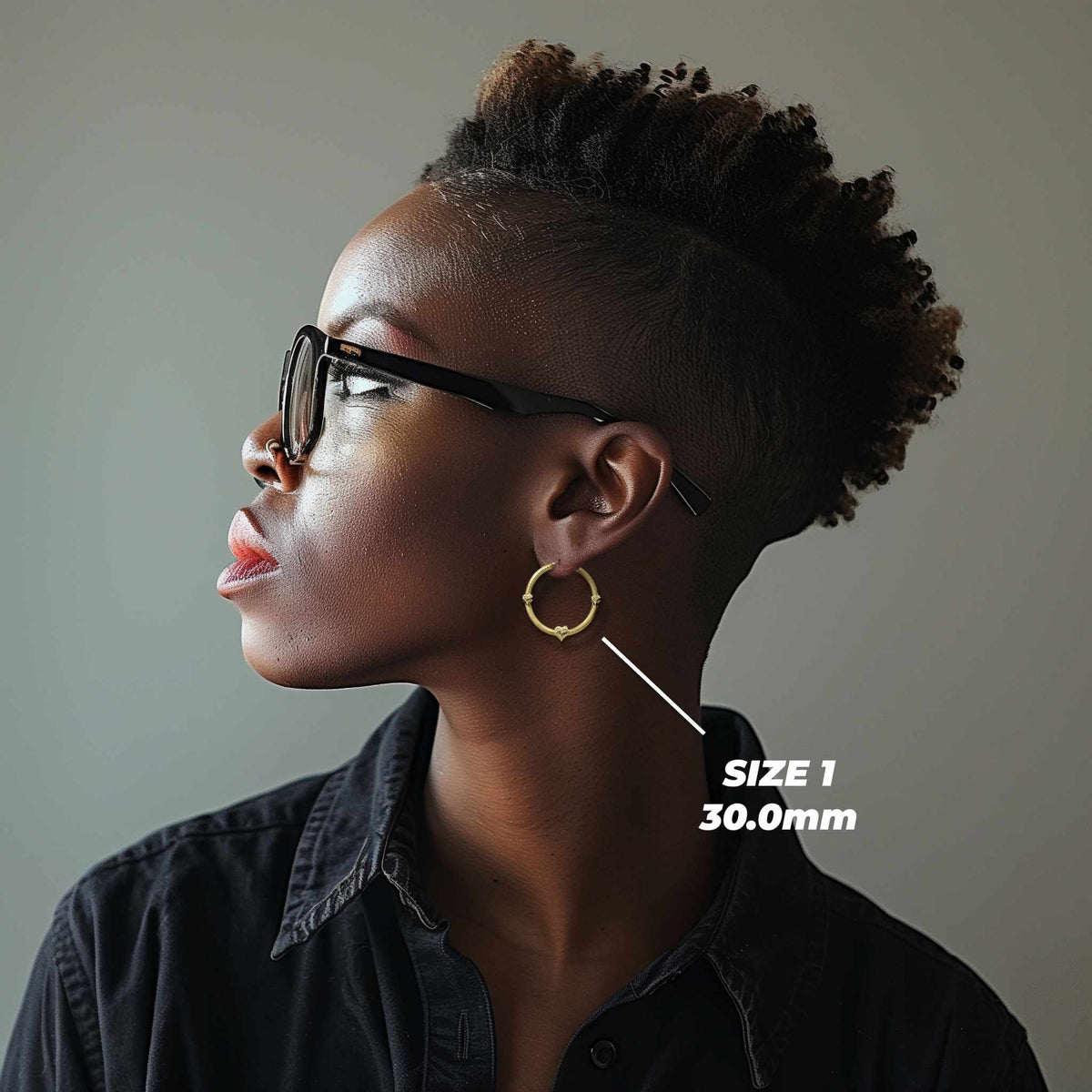 Side profile of a model wearing the 30.0mm Size 1 gold tre heart hoop.