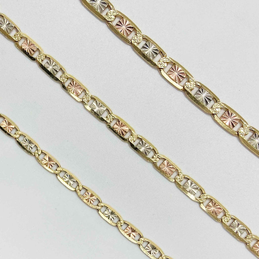 Three tri-color gold Valentino chains with star-patterned links displayed diagonally on white background.