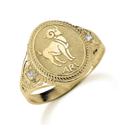 Yellow gold Aries signet ring featuring cubic zirconia accents and textured detailing.