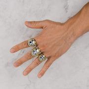 Model displaying three yellow gold king lion head rings with white gold faces on fingers.