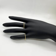 Ultra slim gold rope ring worn on finger, lifestyle shot