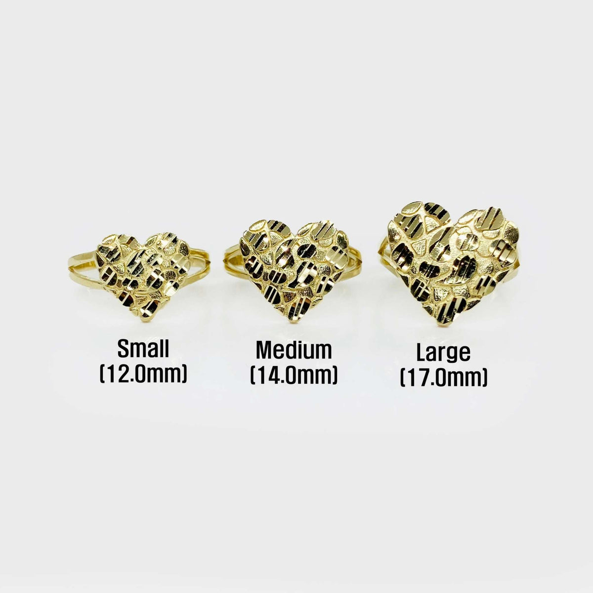 Three gold Velin Nugget heart-shaped rings of different sizes on a white background