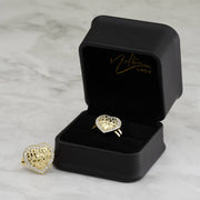 Textured gold heart nugget rings with cubic zirconia borders presented in a branded jewelry box.