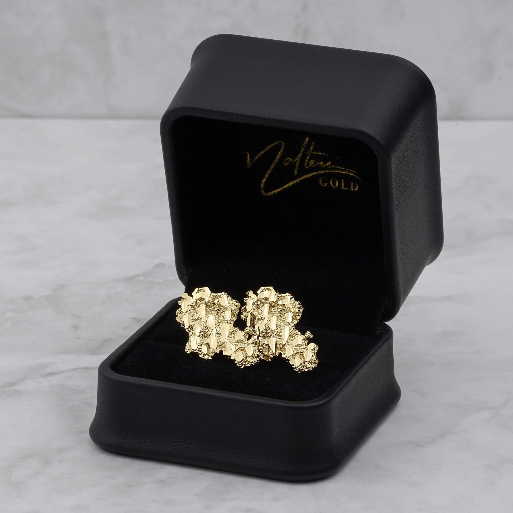 10k and 14k gold vintage nugget stud earrings inside an open black jewelry box.