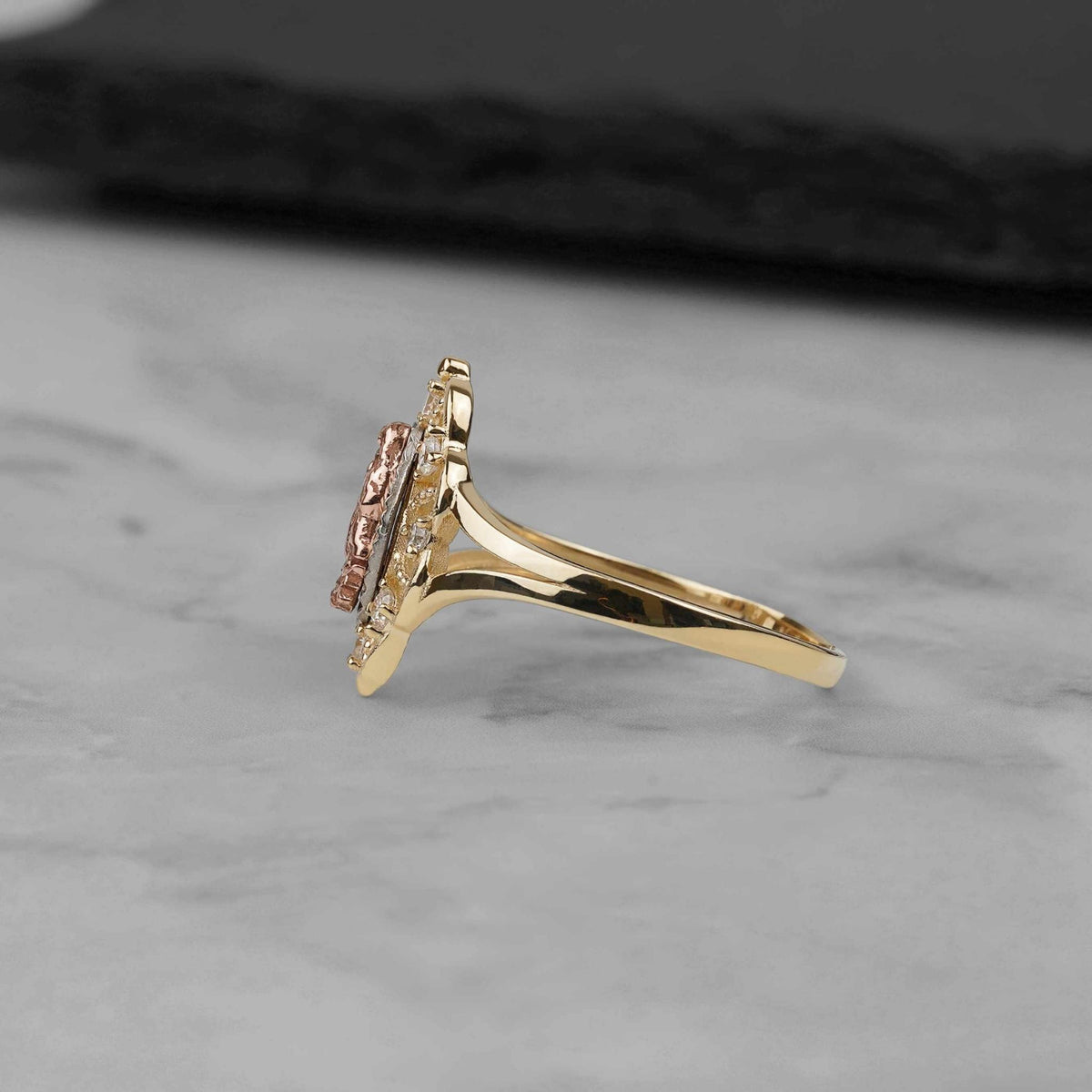 Side angle shot displaying the profile of the tricolor gold Virgin Mary ring.