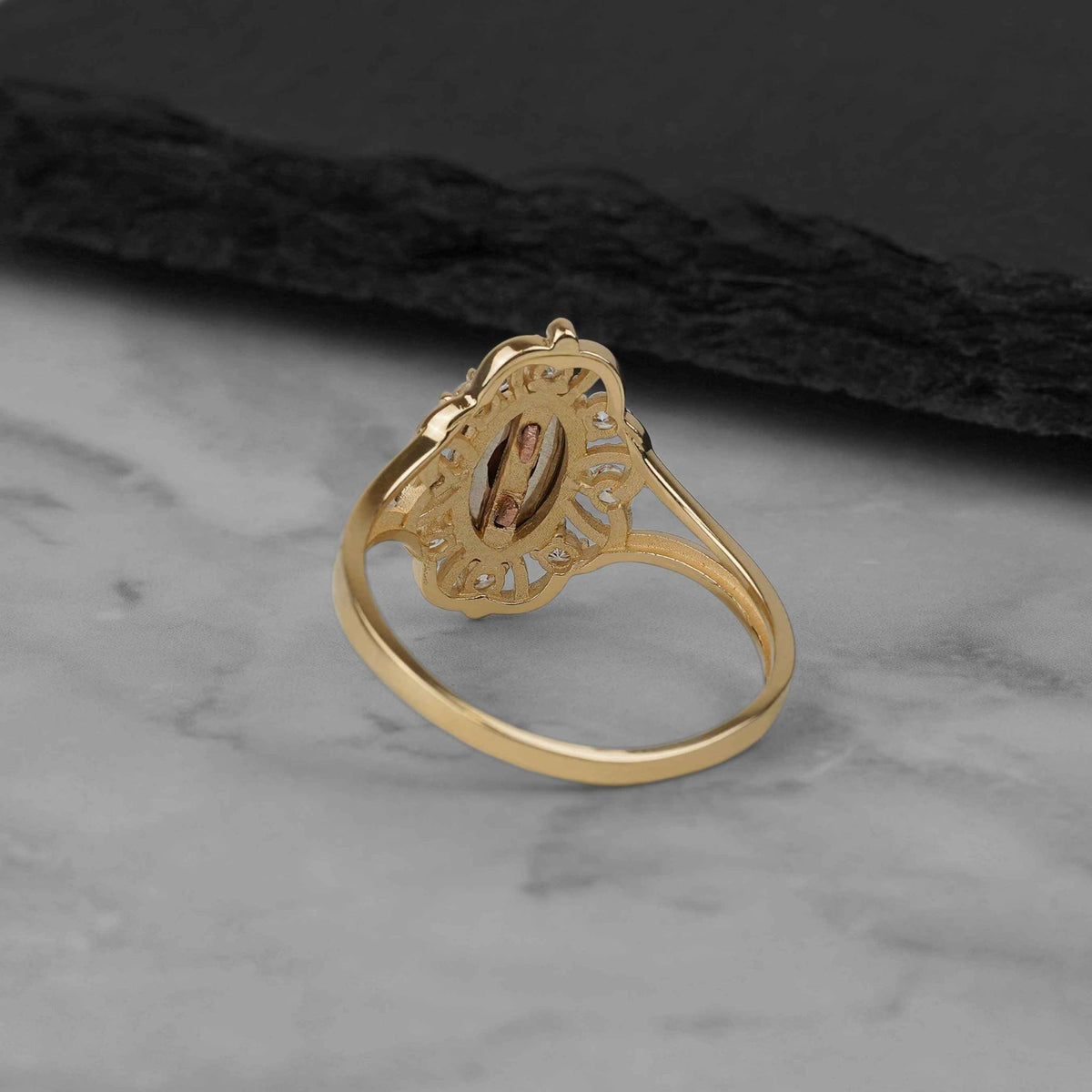 Back view of the tricolor gold Virgin Mary ring displaying its solid polished band.