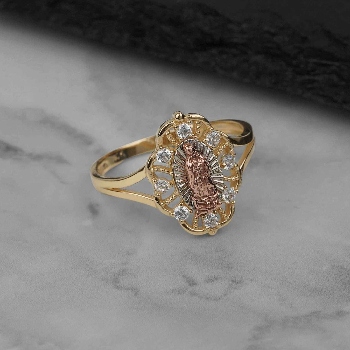 Tricolor gold Virgin Mary ring featuring a detailed center figure surrounded by sparkling stones.