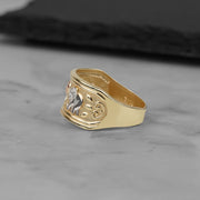Side view of a 10k and 14k tricolor gold lucky elephant ring on marble.