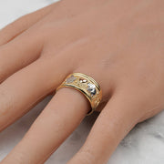 Close-up of a hand wearing the tricolor gold lucky elephant ring.